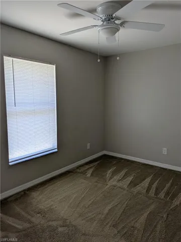 Neutral-toned walls complement the textured carpet flooring