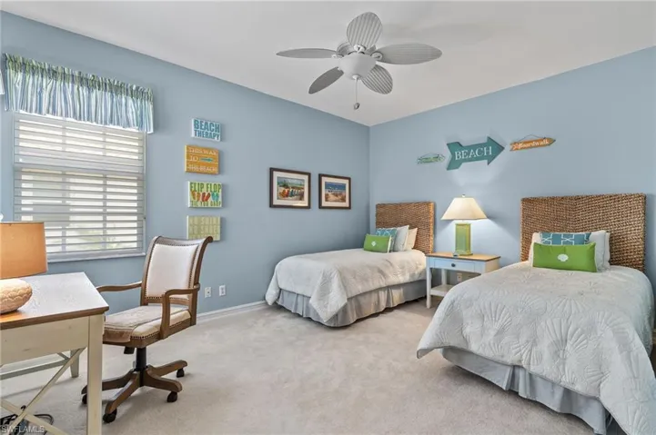 Guest bedroom with twin beds, ceiling fan and walk in closet.
