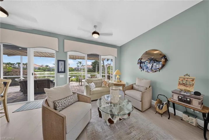 Spacious interior featuring light wood-finish flooring and a vaulted ceiling