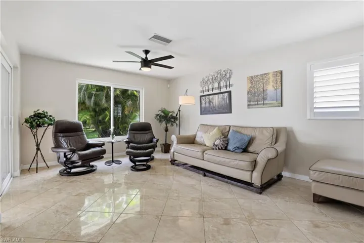 View of Family Room with Panoramic Impact Window which Overlooks Backyard.