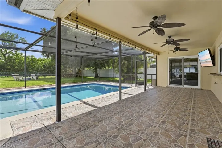 Large Rear Lanai: Space for Comfortable Entertaining, Pool, Family Room Sliders.
