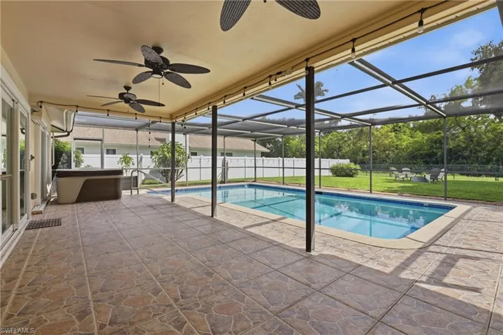Large Enclosed Rear Lanai, Separate Hot Tub, Heated Saltwater Pool, Space for Outdoor Dining & Parties, Space. Plus, Expansive Backyard.