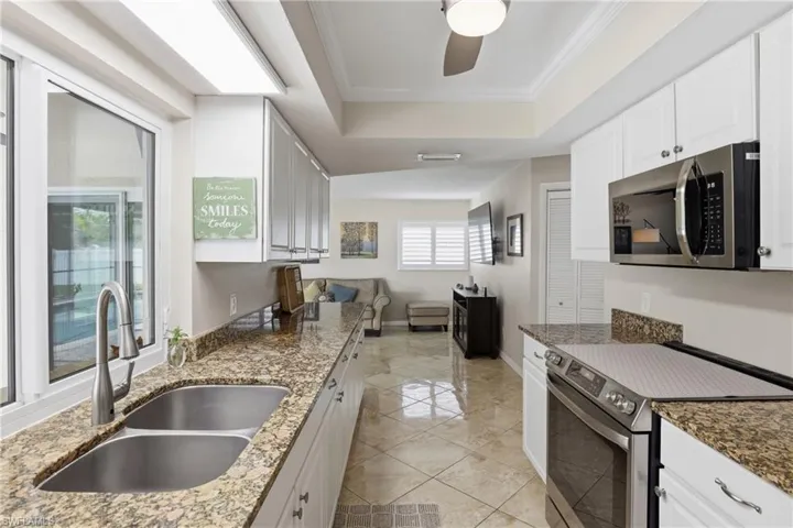 Convenient Kitchen Pantry has Louvered Door. Kitchen is next to Family Room.