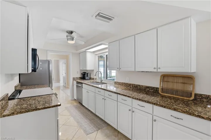 Kitchen - Lots of White Cabinetry, Granite Counters & Stainless Steel Appliances.
