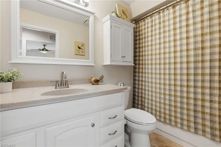 Guest Bathroom: Toilet/Bidet, White Cabinetry, & Tub/Shower.