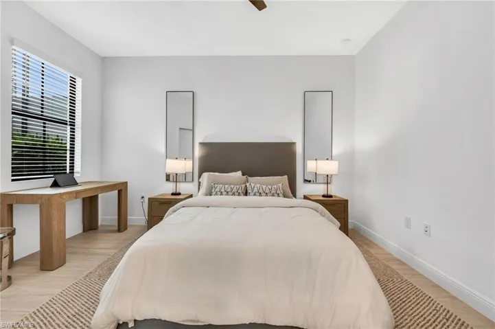 Bright room featuring wood-finish flooring and a ceiling fan