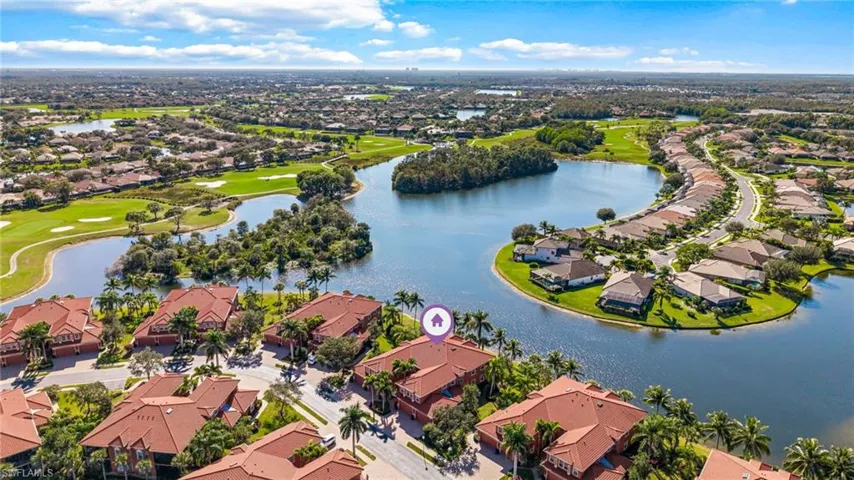 Aerial perspective of suburban area with a nearby body of water and a local golf course