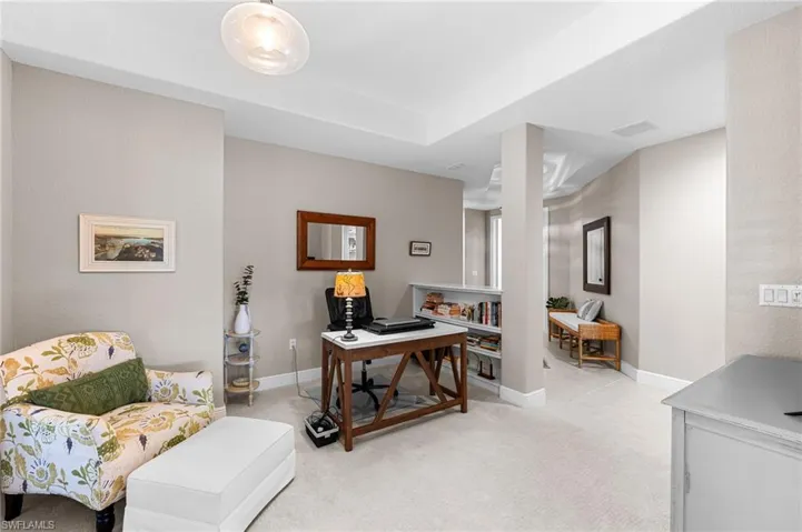 Home office with baseboards and light carpet