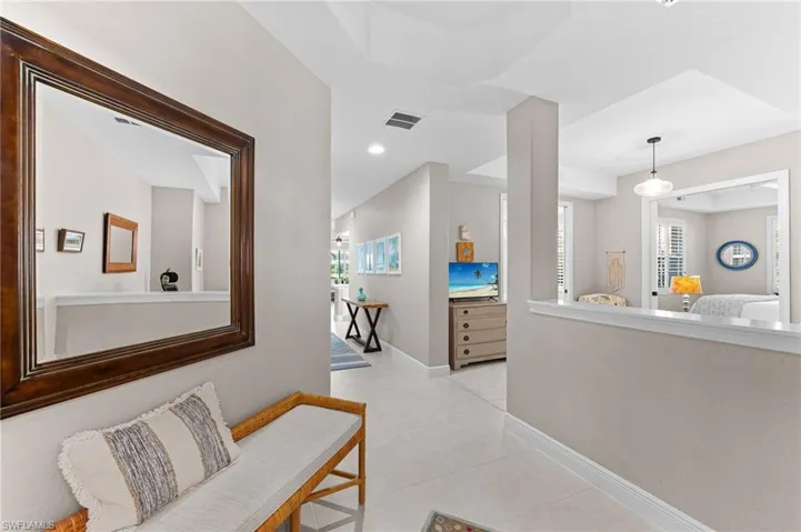 Hall featuring light tile patterned floors and recessed lighting