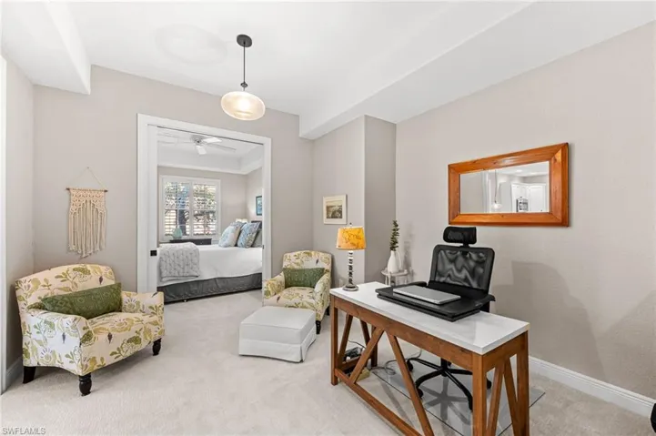 Carpeted office featuring baseboards and ceiling fan