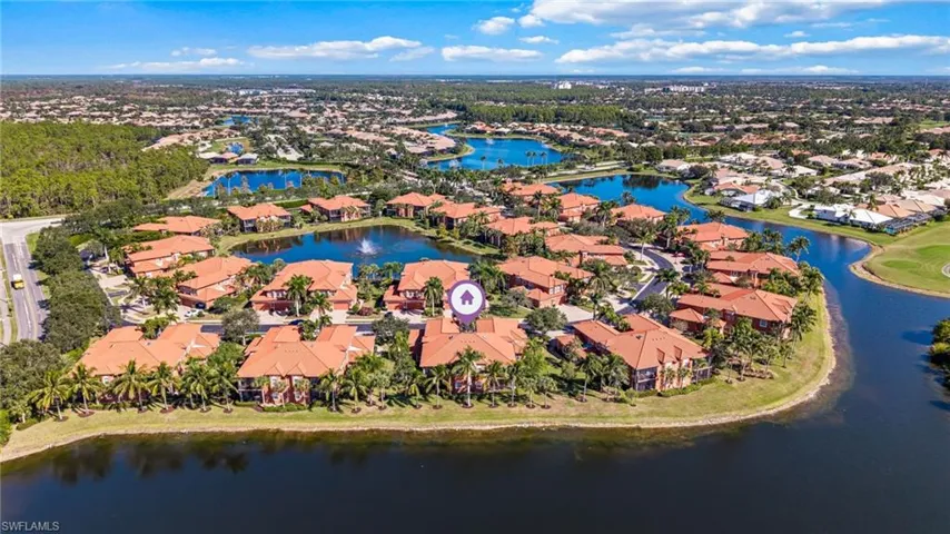 Aerial perspective of suburban area featuring a nearby body of water