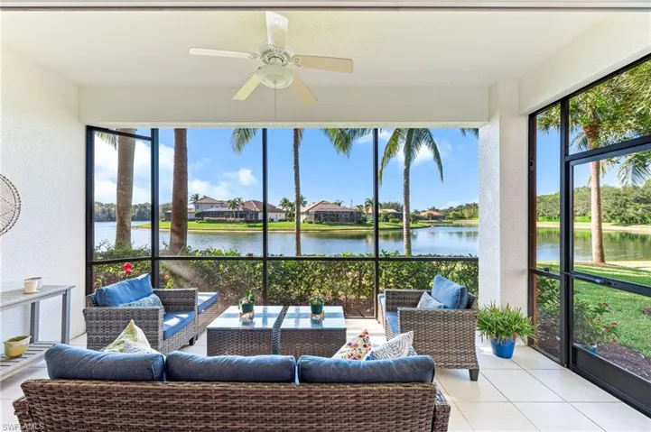 Sunroom with an outdoor living space, a ceiling fan, and a water view