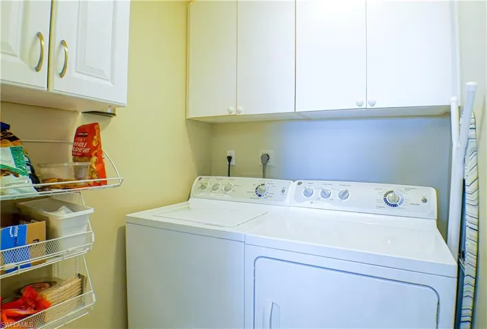 Washroom with cabinets and independent washer and dryer