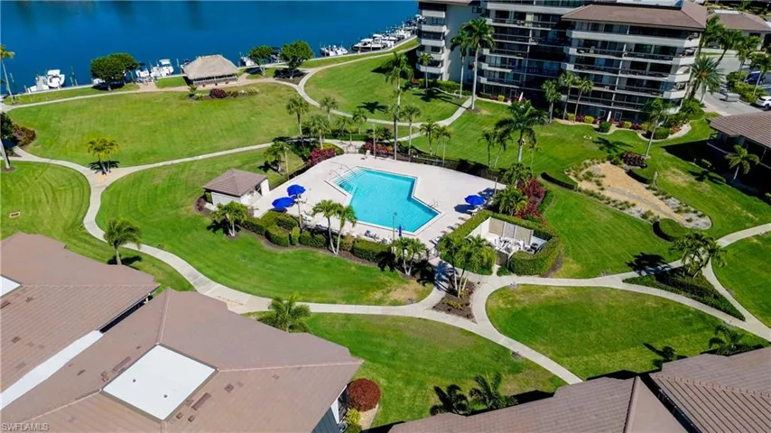 Birds eye view of property with a water view