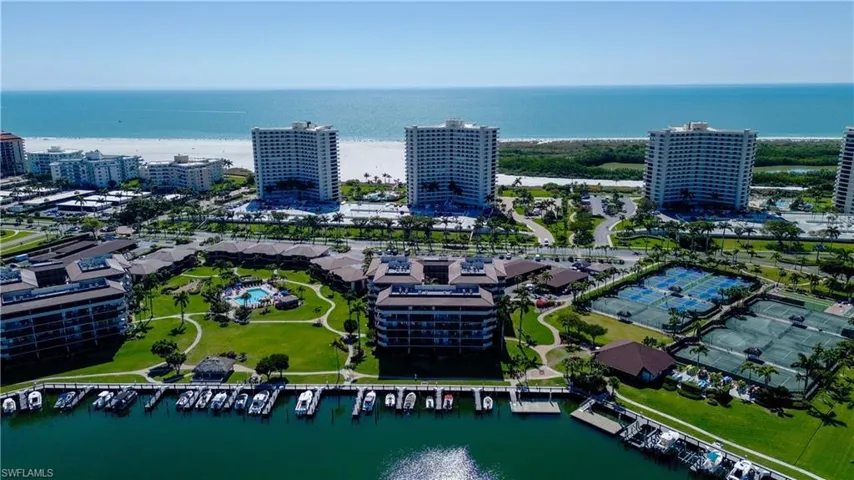 Birds eye view of property with a water view