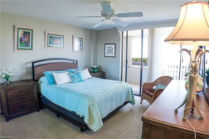 Bedroom with carpet flooring, ceiling fan, and access to outside