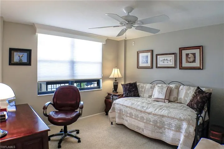 Carpeted bedroom with ceiling fan