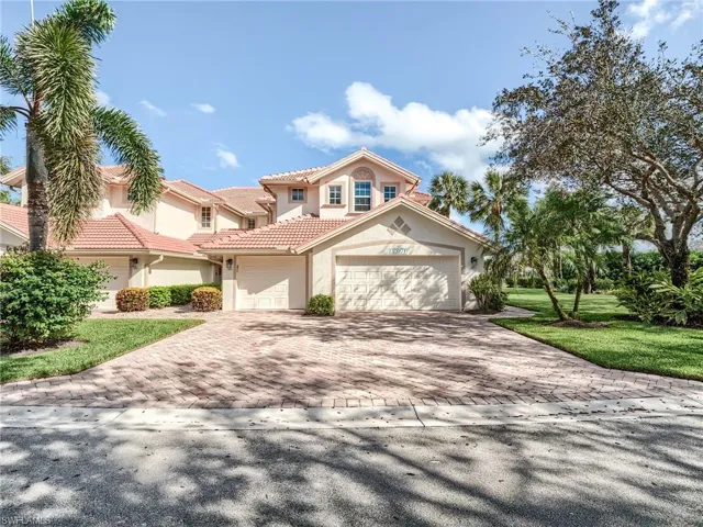Mediterranean / spanish-style home featuring a garage and a front lawn