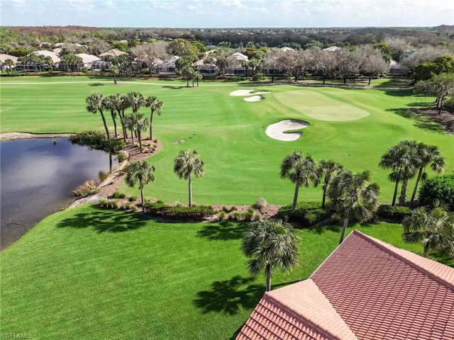 View of home's community with a yard and a water view