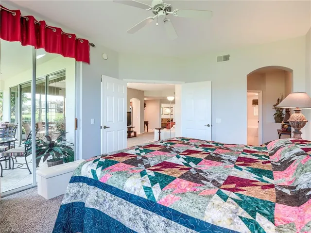 Bedroom with ceiling fan, carpet, and access to exterior