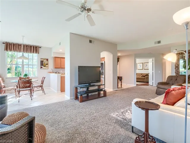 Living room with light carpet and ceiling fan