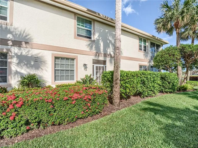 View of side of property with a lawn
