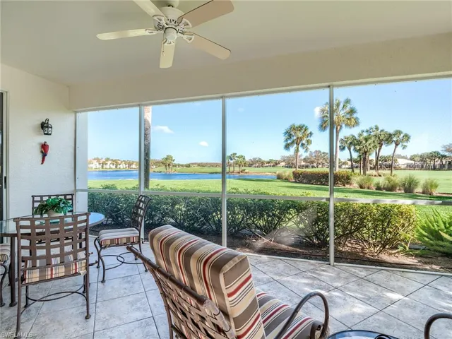Sunroom featuring a water view and ceiling fan