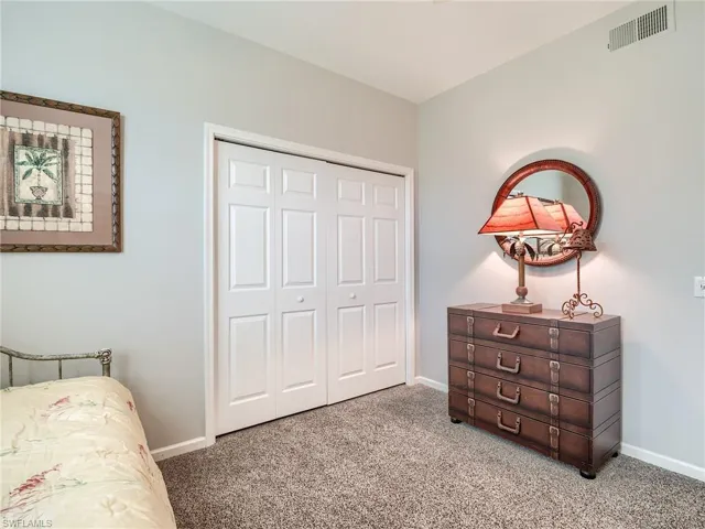 Bedroom with carpet flooring and a closet