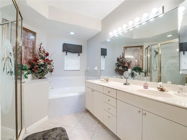 Bathroom featuring vanity, separate shower and tub, and tile patterned floors