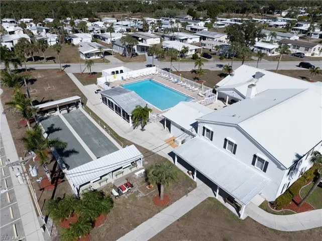 Aerial perspective of suburban area featuring a pool