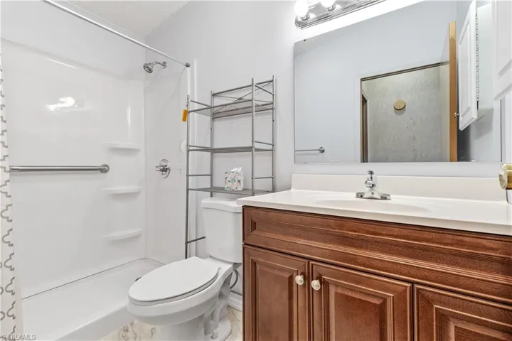 Full bath featuring vanity and curtained shower