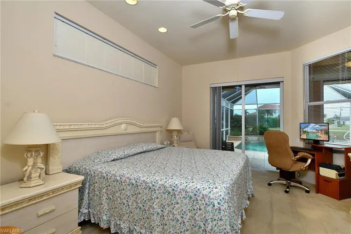 Room featuring a decorative headboard, recessed lighting, and a ceiling fan