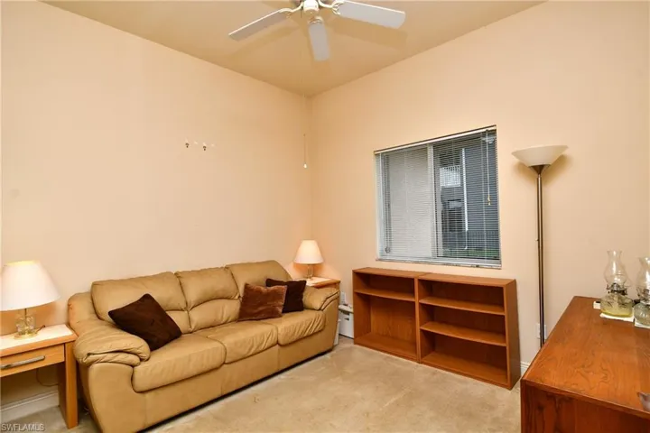 Room featuring high ceilings, neutral wall tones, and carpet flooring