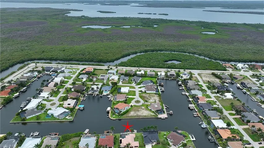 Waterfront property featuring a private boat dock, direct canal access, and a paved patio