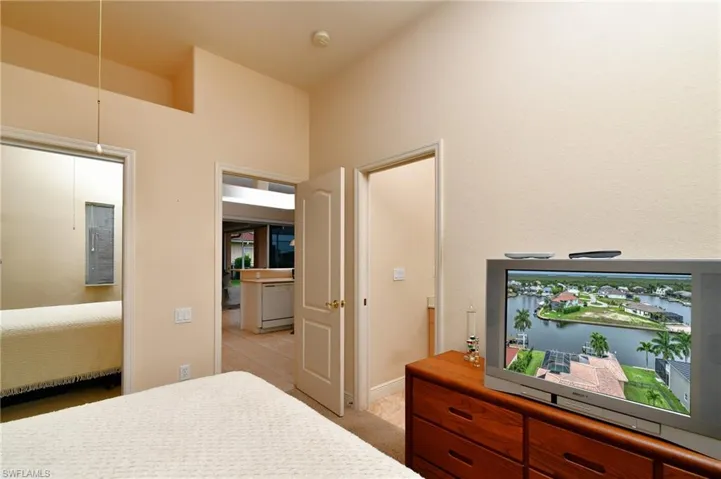 Interior room featuring neutral-toned walls and high ceilings with a recessed architectural detail