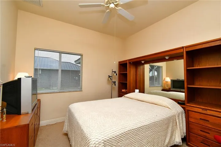 Vaulted ceiling bedroom with a ceiling fan