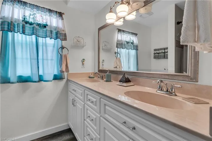 Double vanity featuring light-toned countertops and two undermount sinks