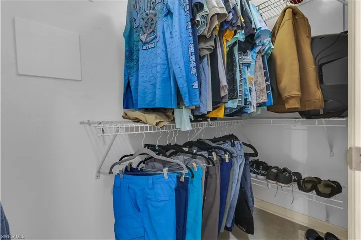 Built-in wire shelving system featuring multiple hanging rods and storage shelves