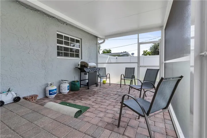 Covered patio featuring paver flooring