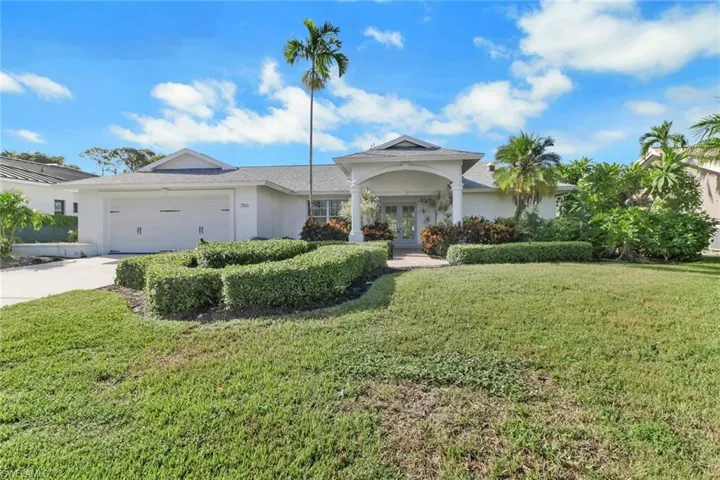 Ranch-style home with a front lawn, concrete driveway, and stucco siding
