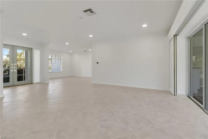 Spare room featuring french doors, light tile patterned floors, recessed lighting, and crown molding