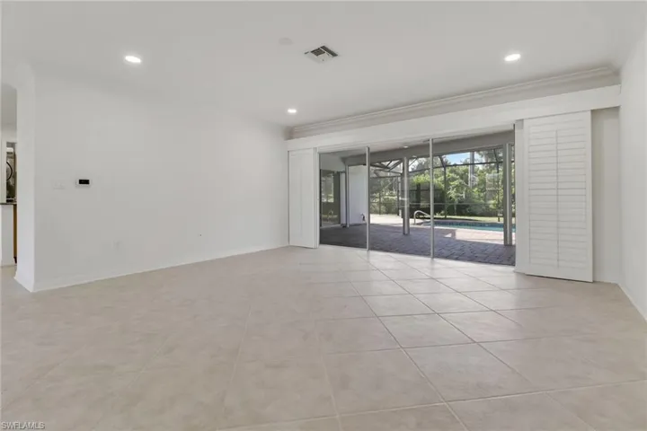 Unfurnished room with a sunroom, light tile patterned floors, and recessed lighting