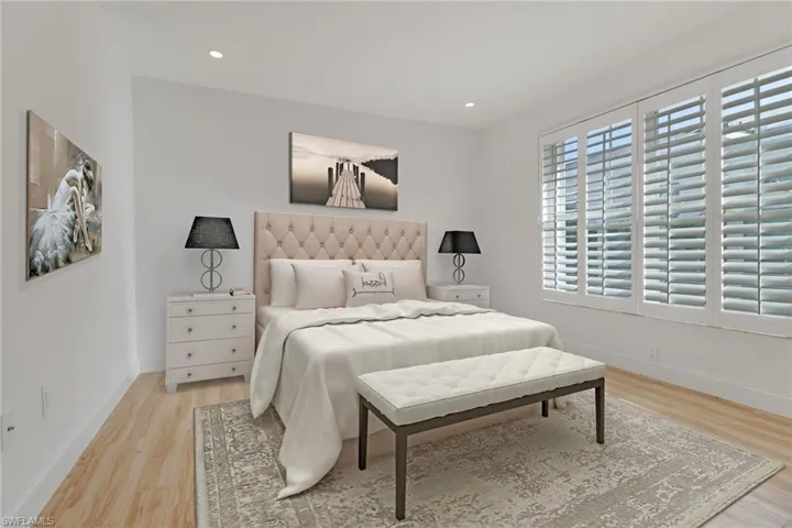 Bedroom with light wood-type flooring and recessed lighting