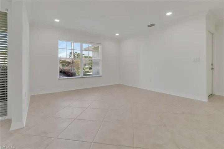Spare room with ornamental molding, light tile patterned flooring, and recessed lighting