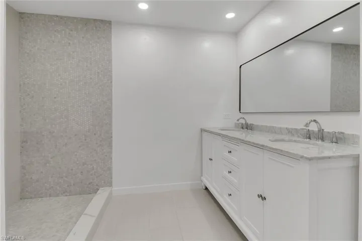 Bathroom featuring double vanity and recessed lighting