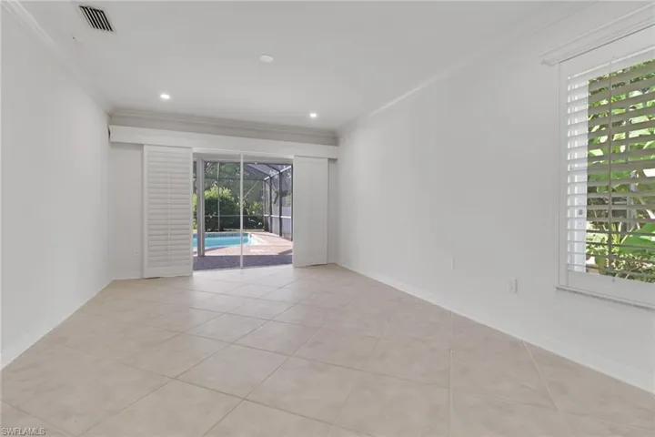 Spare room featuring a sunroom, ornamental molding, light tile patterned floors, and recessed lighting