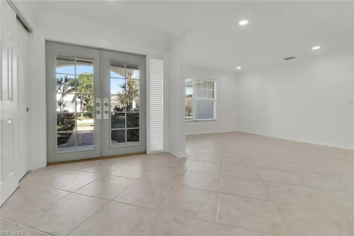 Unfurnished room featuring french doors, ornamental molding, recessed lighting, and light tile patterned flooring
