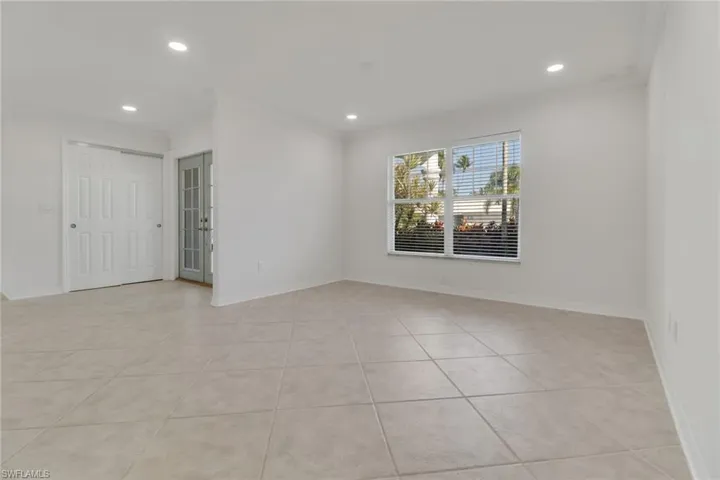 Unfurnished room with crown molding, recessed lighting, and light tile patterned floors