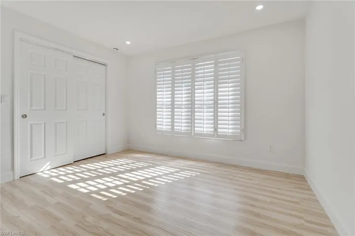 Unfurnished bedroom with light wood-style flooring, a closet, and recessed lighting