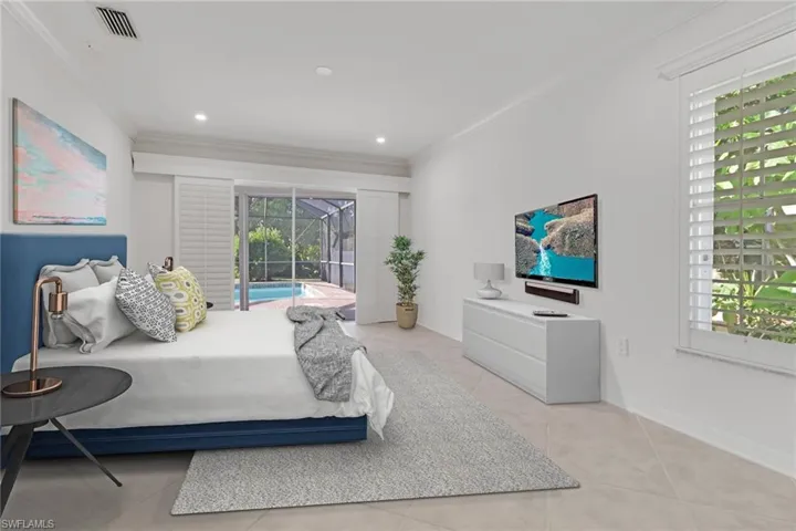 Bedroom featuring crown molding, access to exterior, light tile patterned floors, a sunroom, and recessed lighting